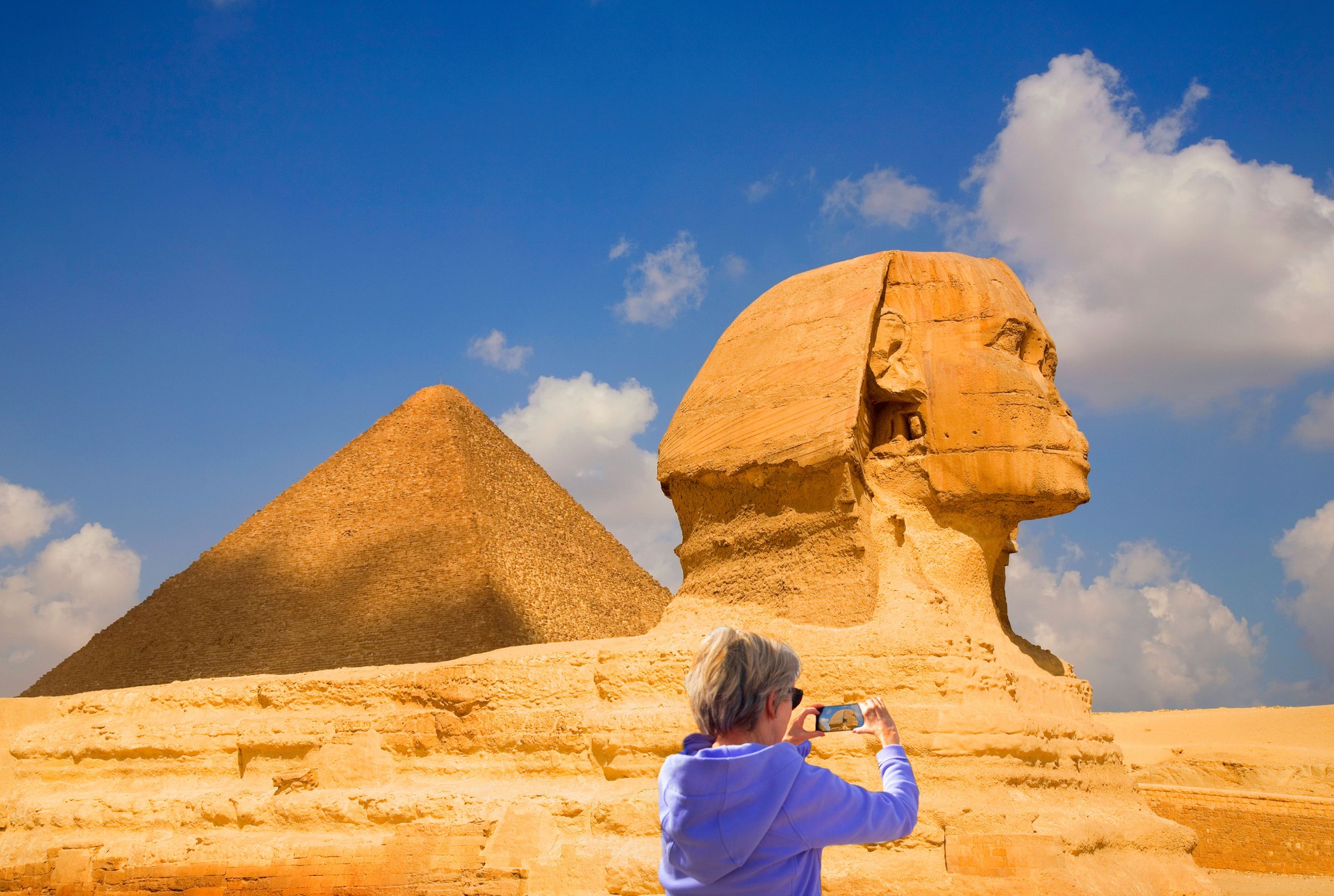 Woman takes photo of The Great Sphinx of Giza